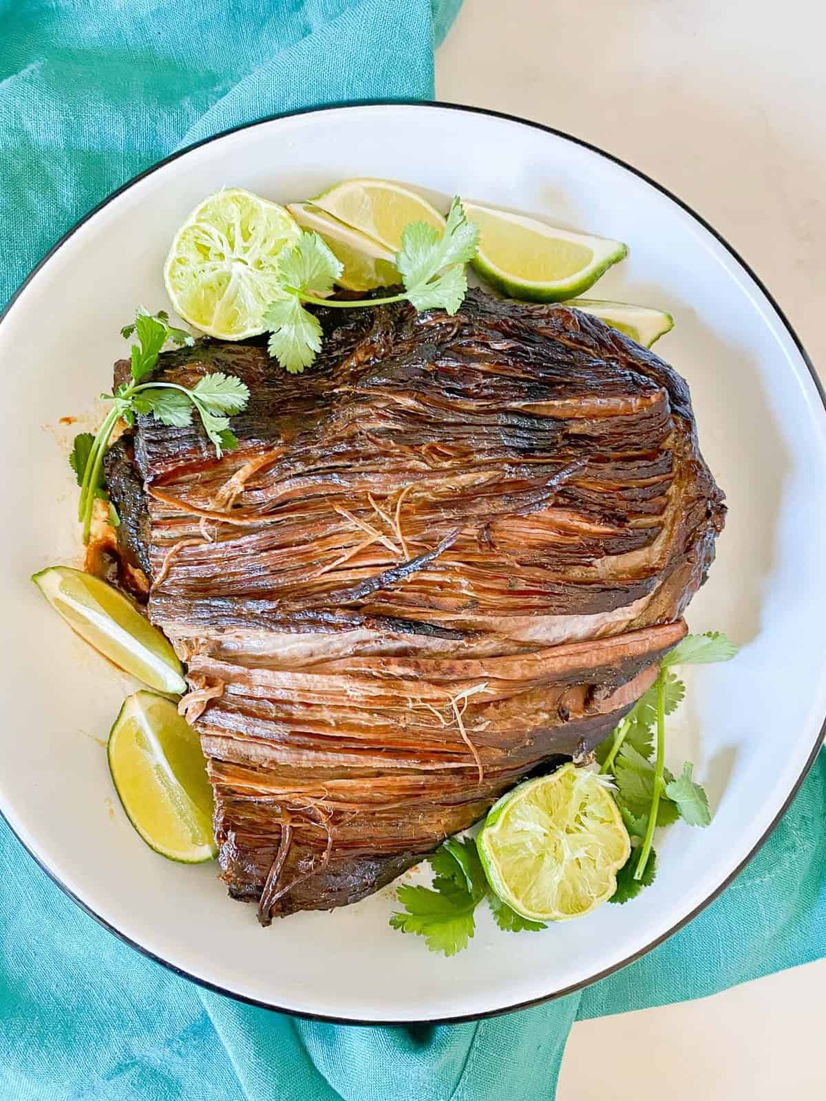 shredded beef taco recipe served with fresh limes