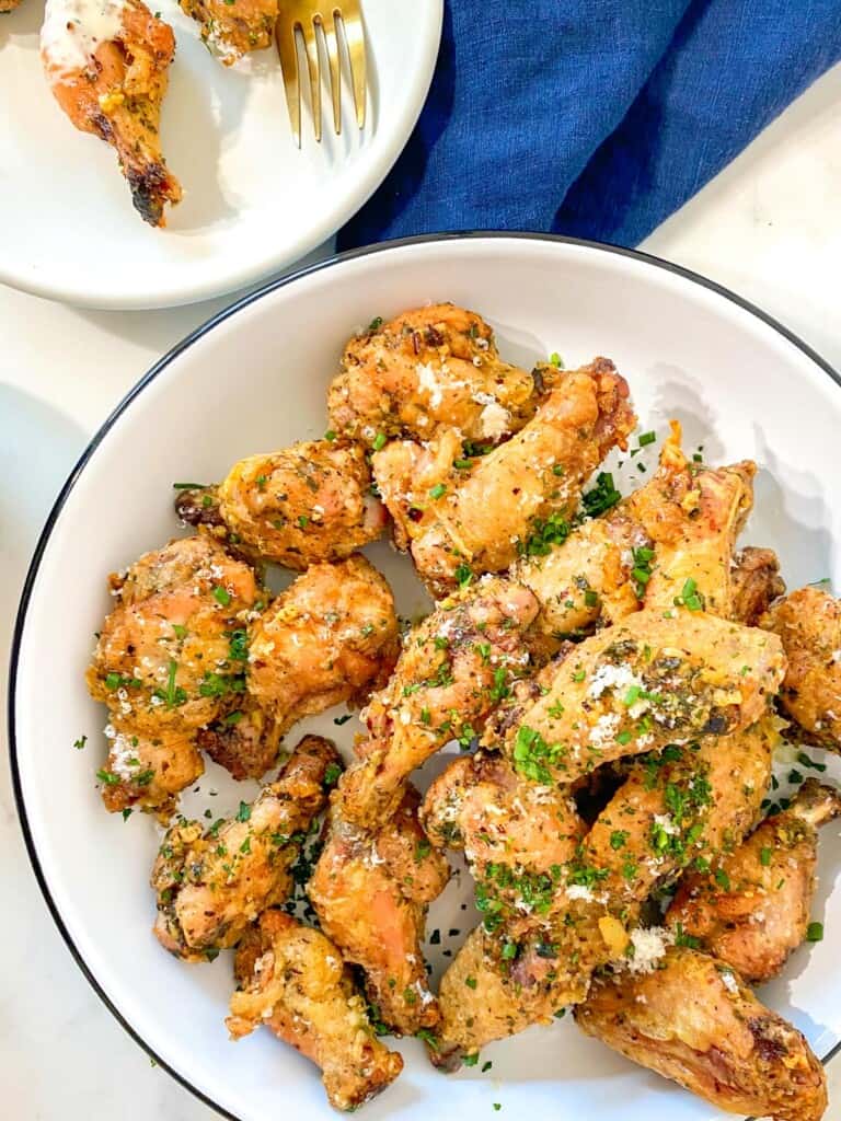 crispy garlic parmesan wings in a white bowl