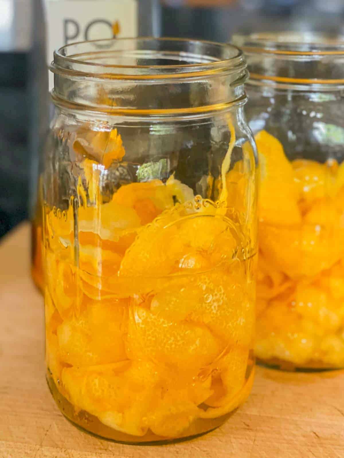lemon peels in mason jars with spirit alcohol, making limoncello