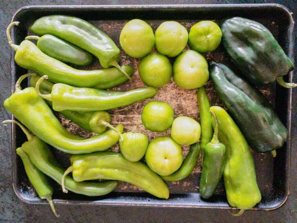 a pan of chilis and tomatillos for making chile verde sauce