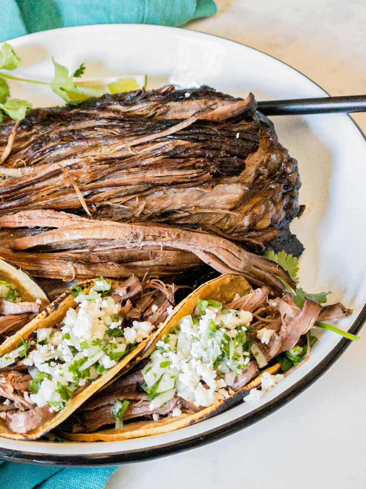 shredded beef tacos in a dish