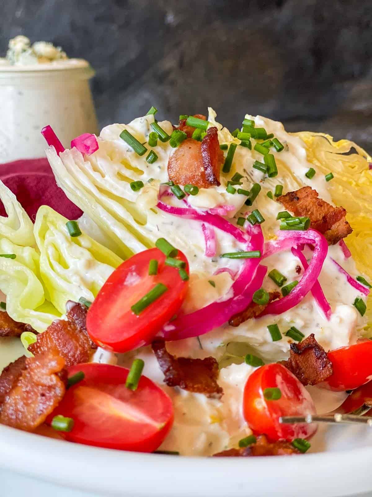 classic blue cheese wedge salad with all the toppings and homemade blue cheese dressing