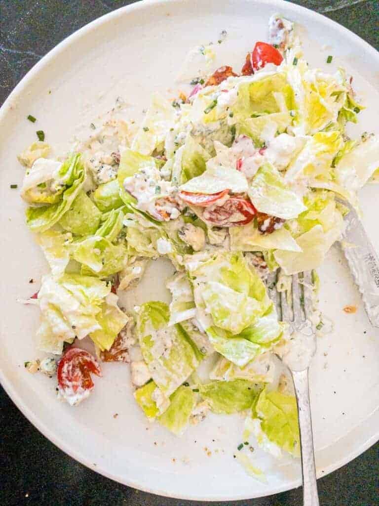 slice the wedge salad up into pieces and toss all the topping together.