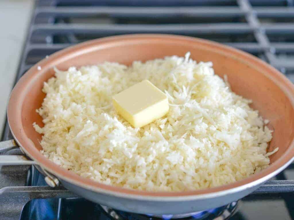 add cauliflower and butter to a sauté pan