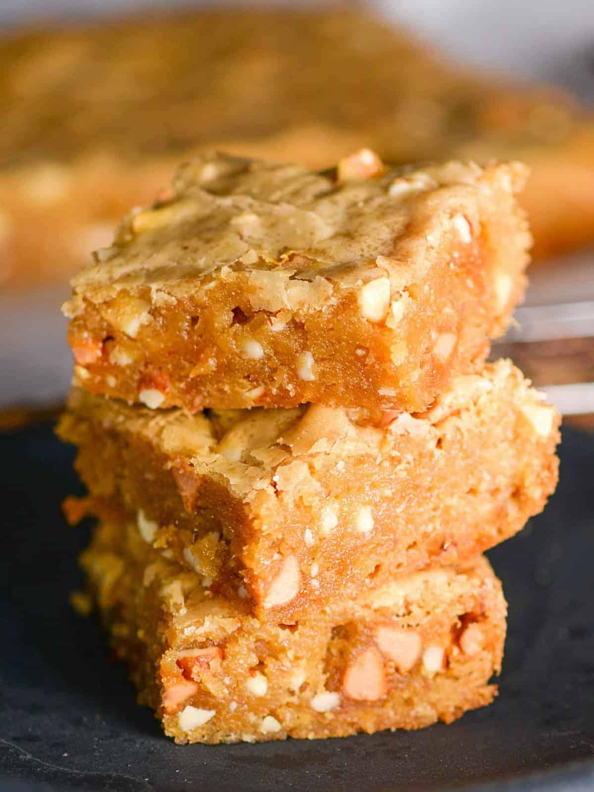 A stack of blondies with butterscotch chips and nuts