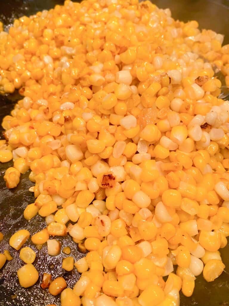 charred and buttered corn in a heavy skillet