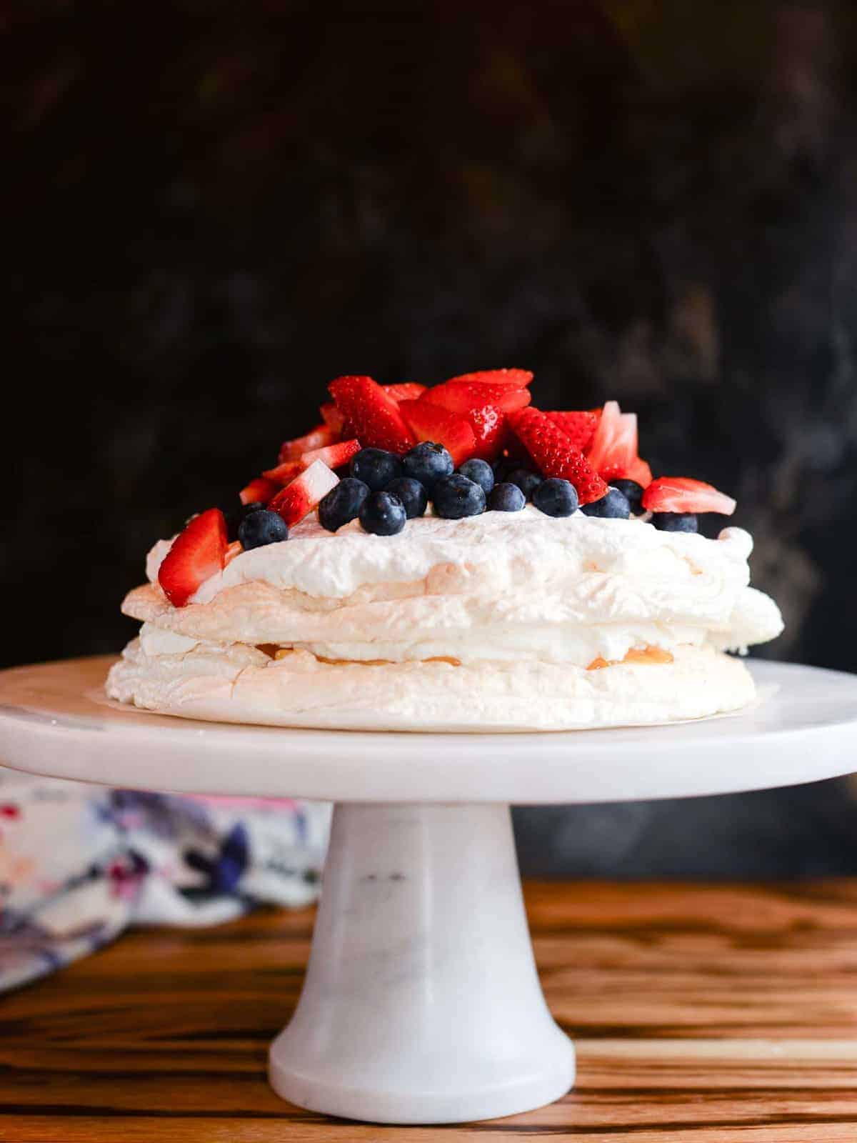 layered pavlova recipe, crispy chewy meringue layered with berries, lemon curd and fresh fruit