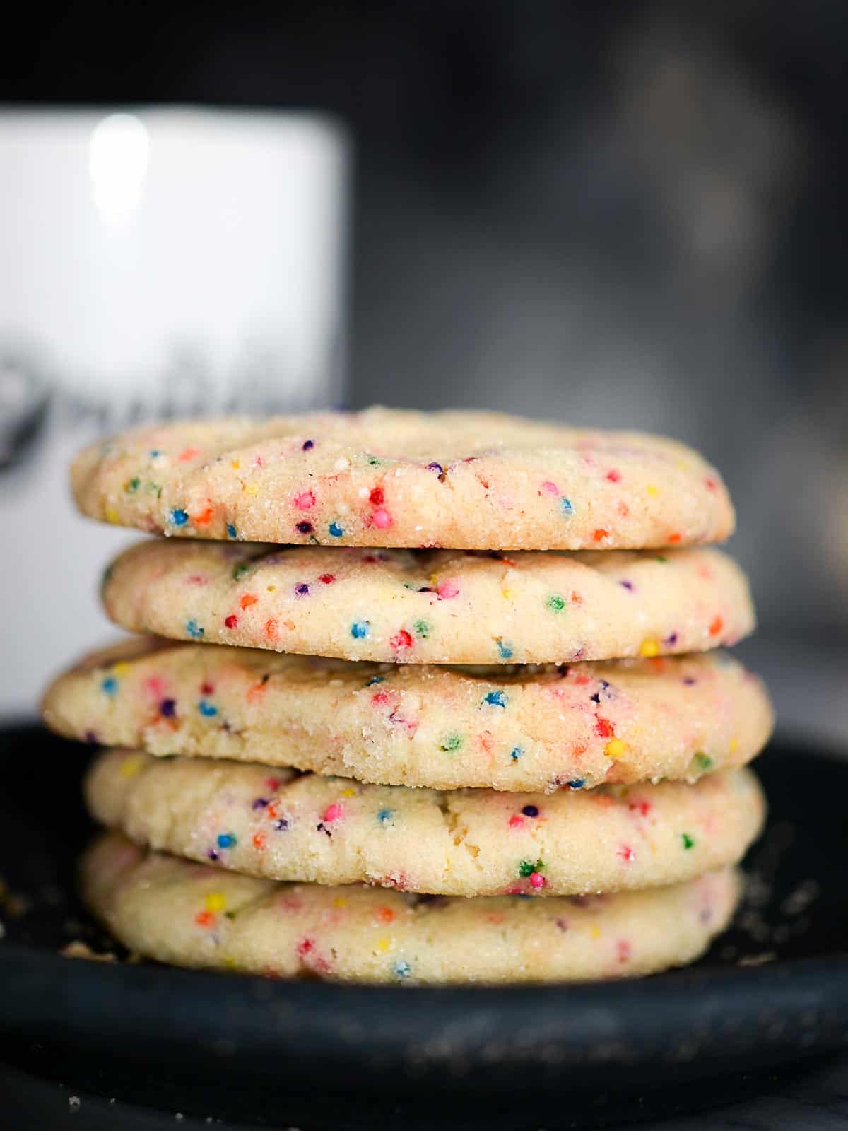 a stack of light and crispy sugar cookies made with sprinkles
