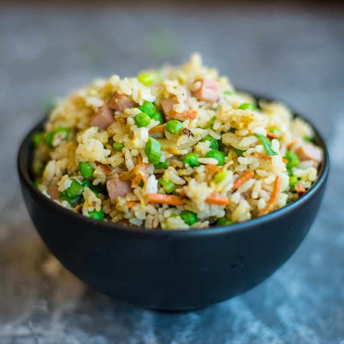 spam fried rice in a black bowl