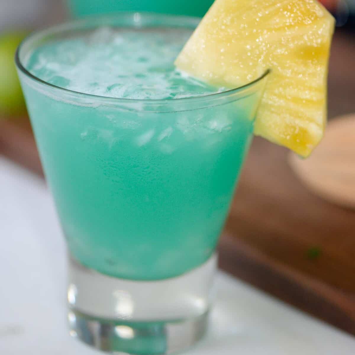 blue hawaii cocktail with pineapple and a cherry