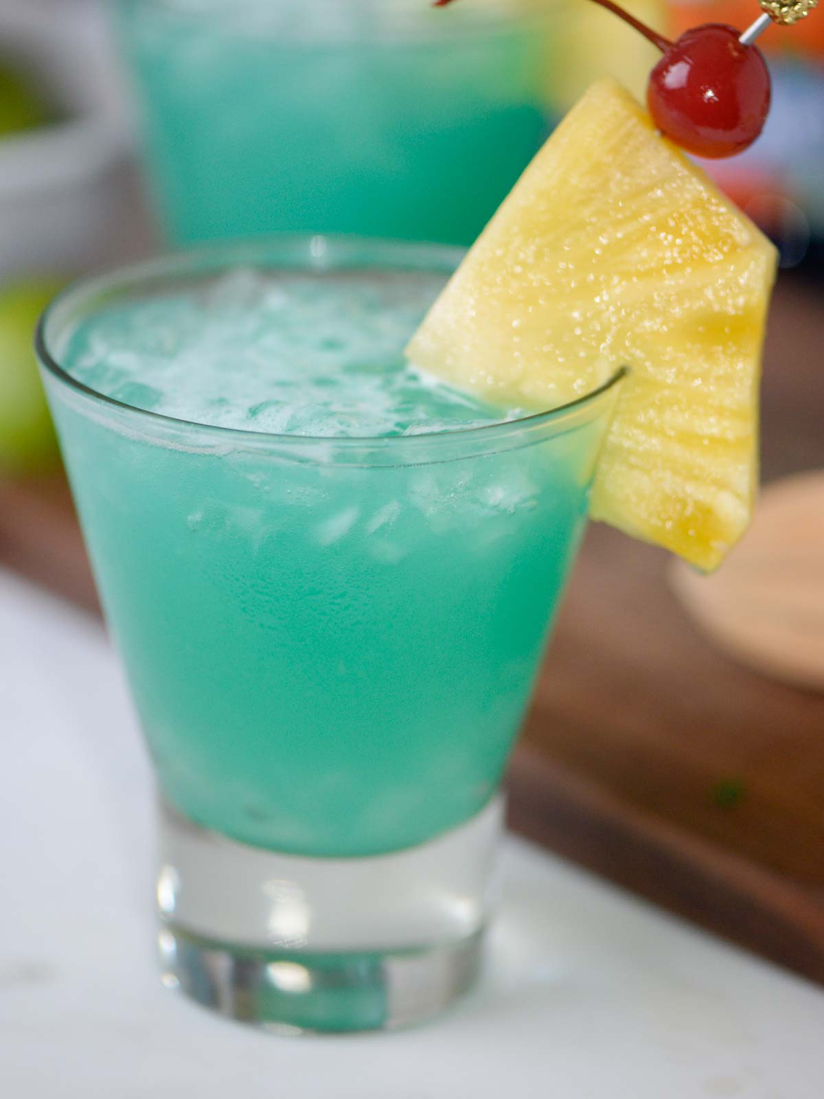 blue hawaii cocktail with pineapple and a cherry