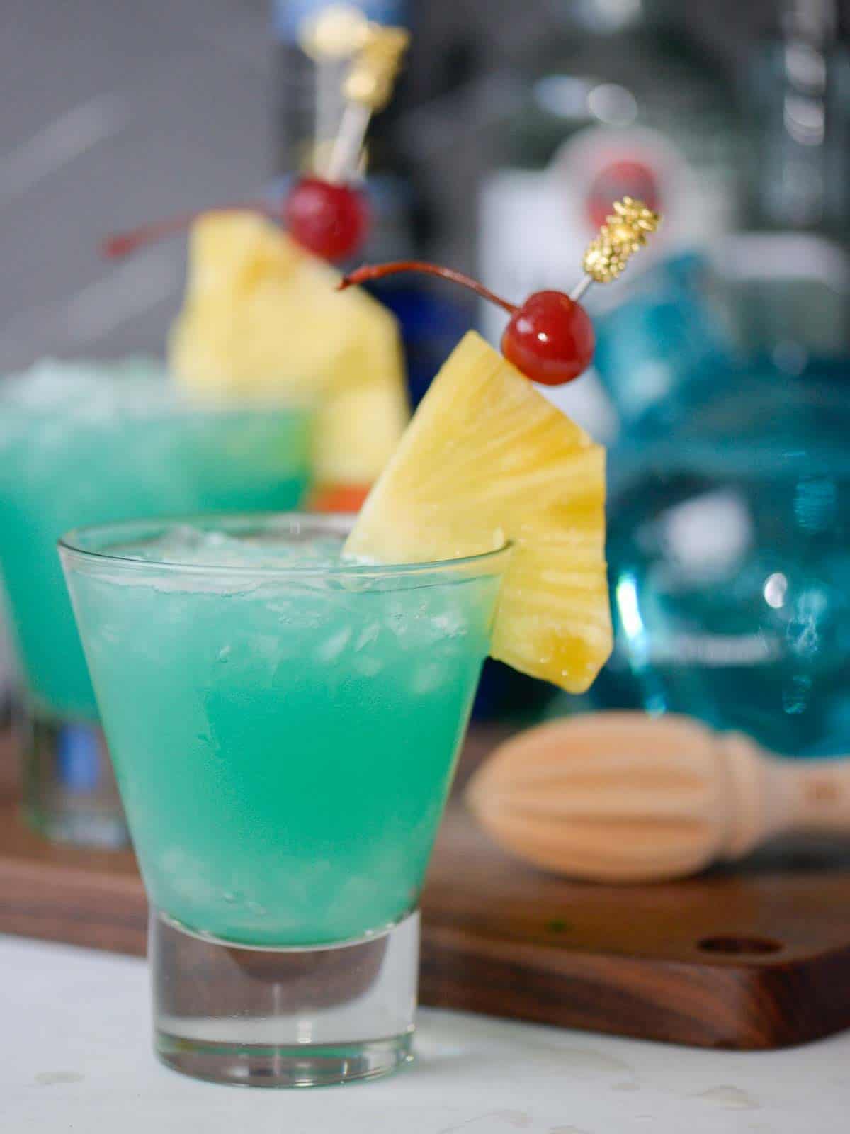 blue hawaii cocktails with pineapple and cherries