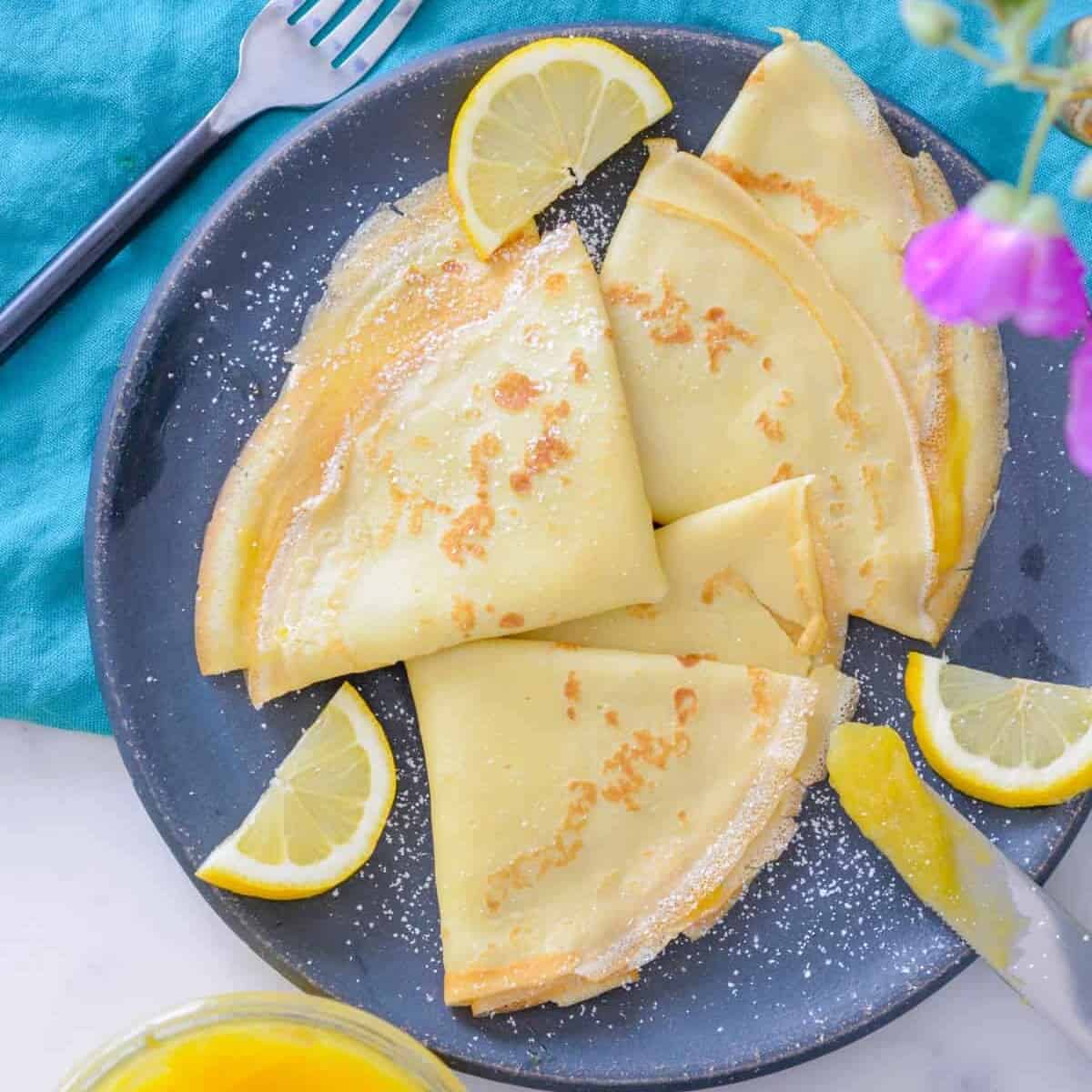 french crepes with lemon curd and powdered sugar