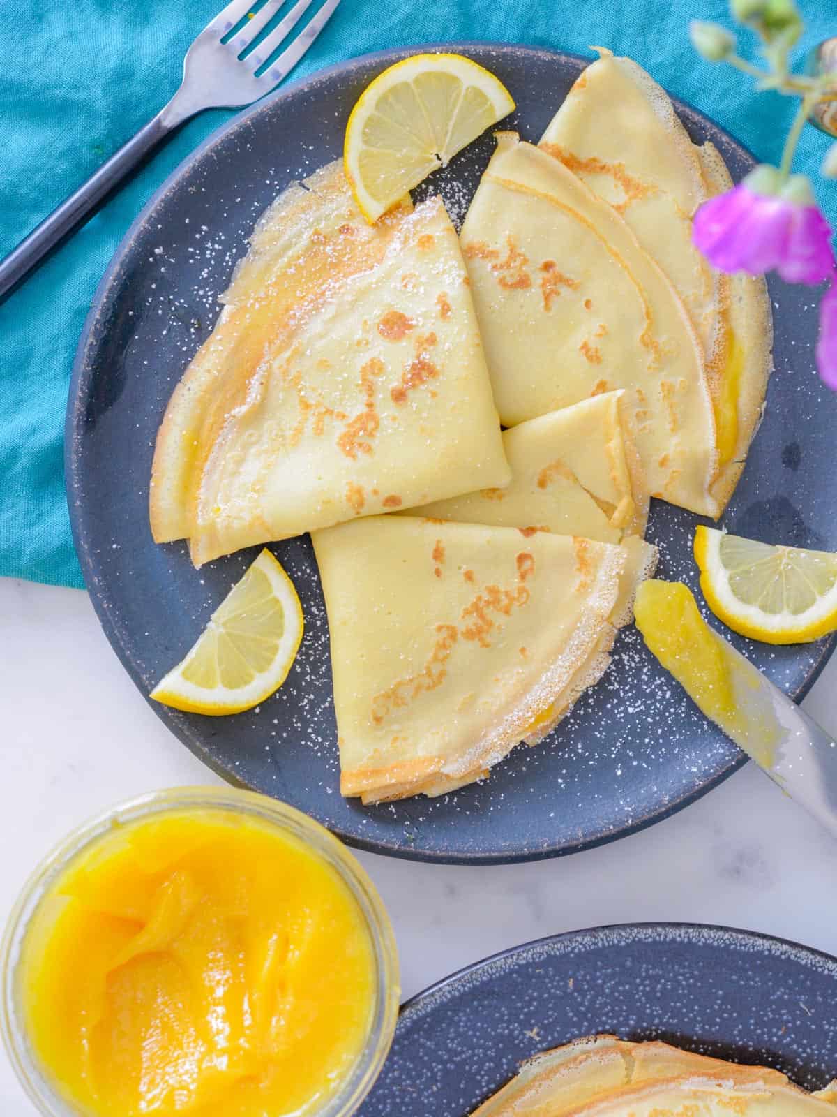 french crepes with lemon curd and powdered sugar