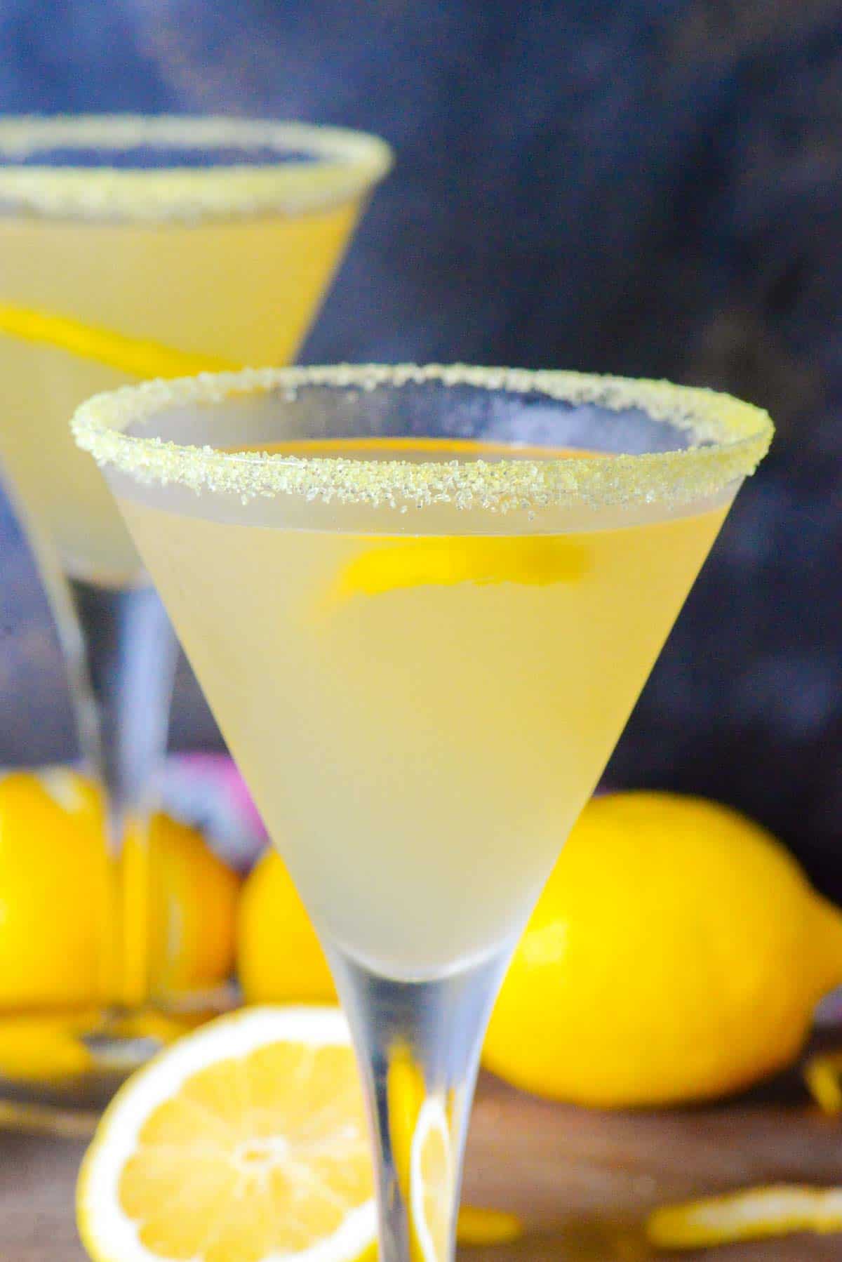 two lemon drop martini cocktails garnished with a twist of lemon