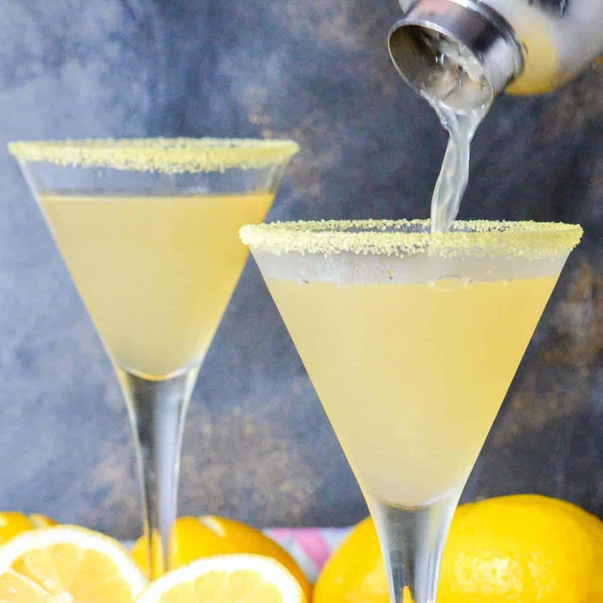two lemon martinis being poured