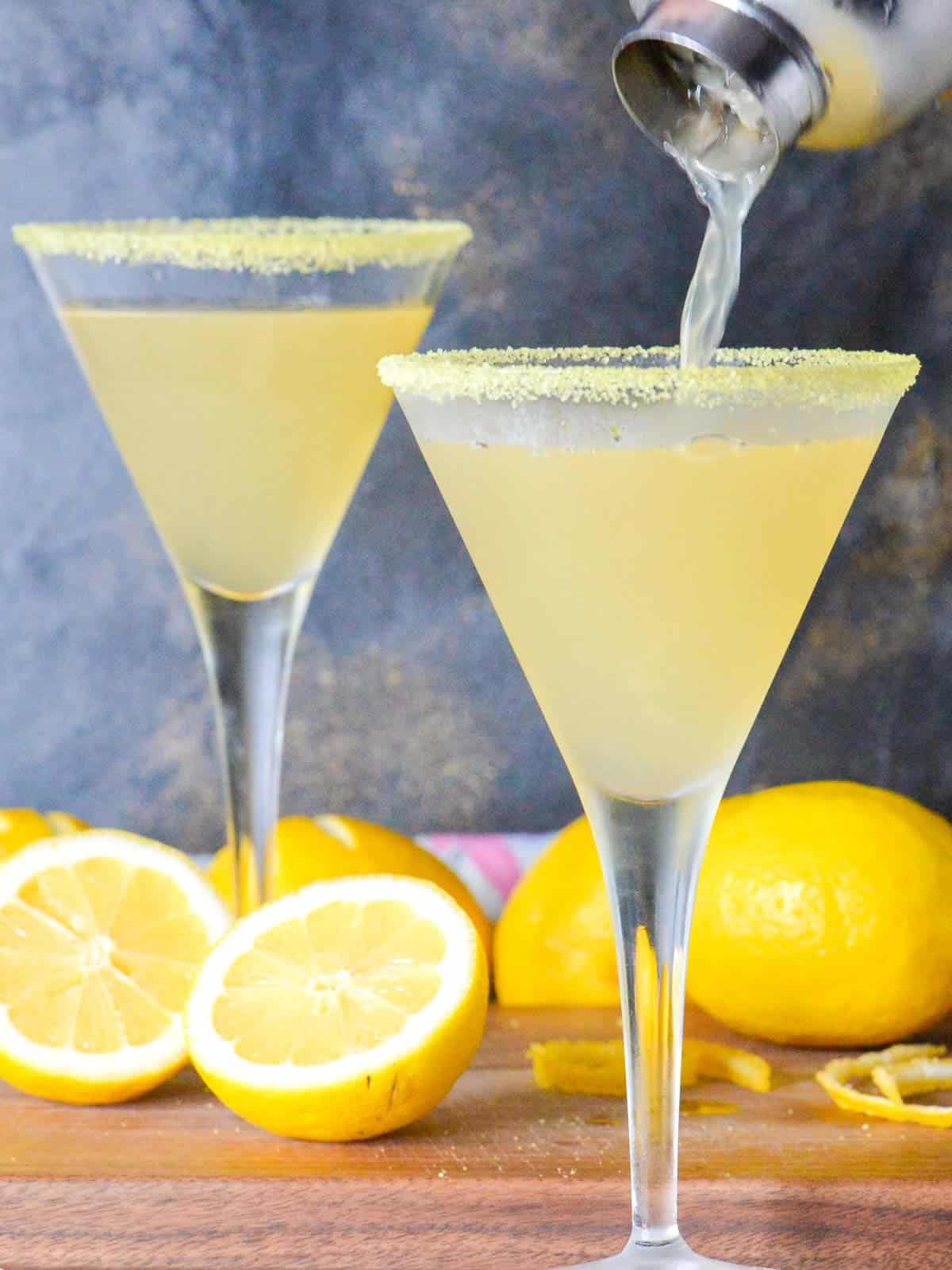 two lemon martinis being poured