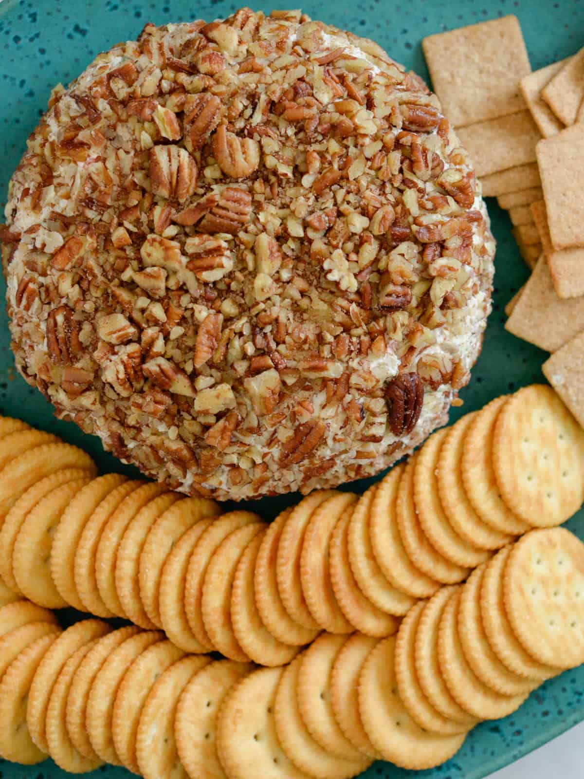 pineapple pecan cheese ball with ritz crackers and wheat thins