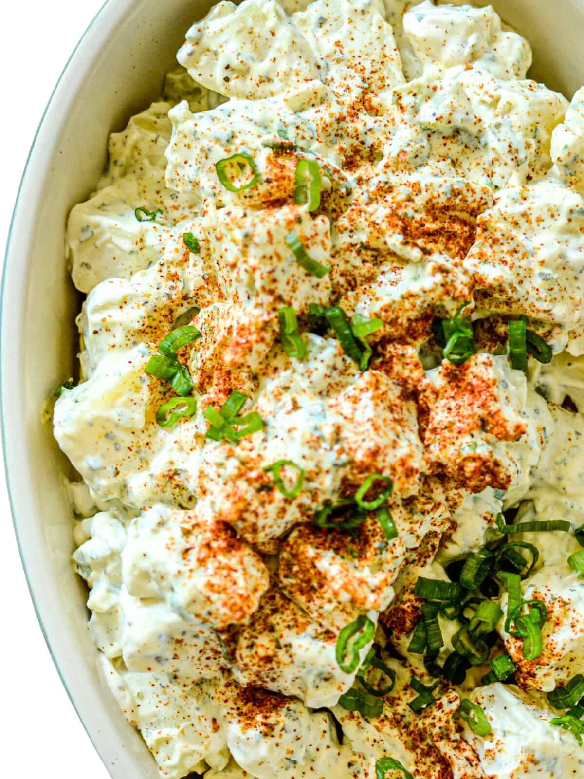easy potato salad recipe topped with a sprinkle of paprika and green onions