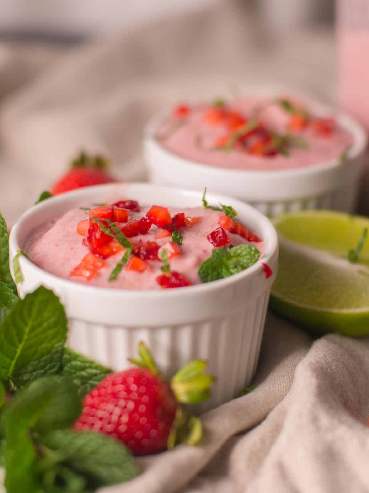 strawberry vegan ice cream topped with fresh strawberries and mint