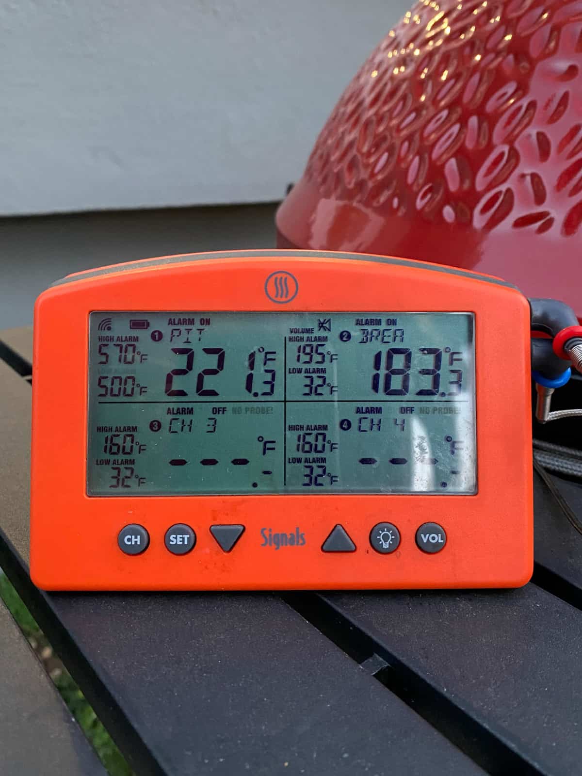 digital thermometer with 2 probes attached to monitor the grill temp and meat temp