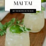 PInterest Pin for the trader vic's mai tai in a rocks glass, garnished with lime and mint