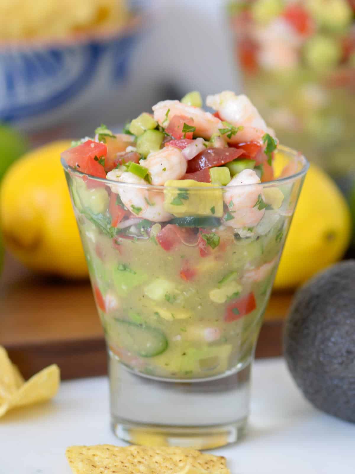 shrimp ceviche is a stemless glass, served with tortilla chips