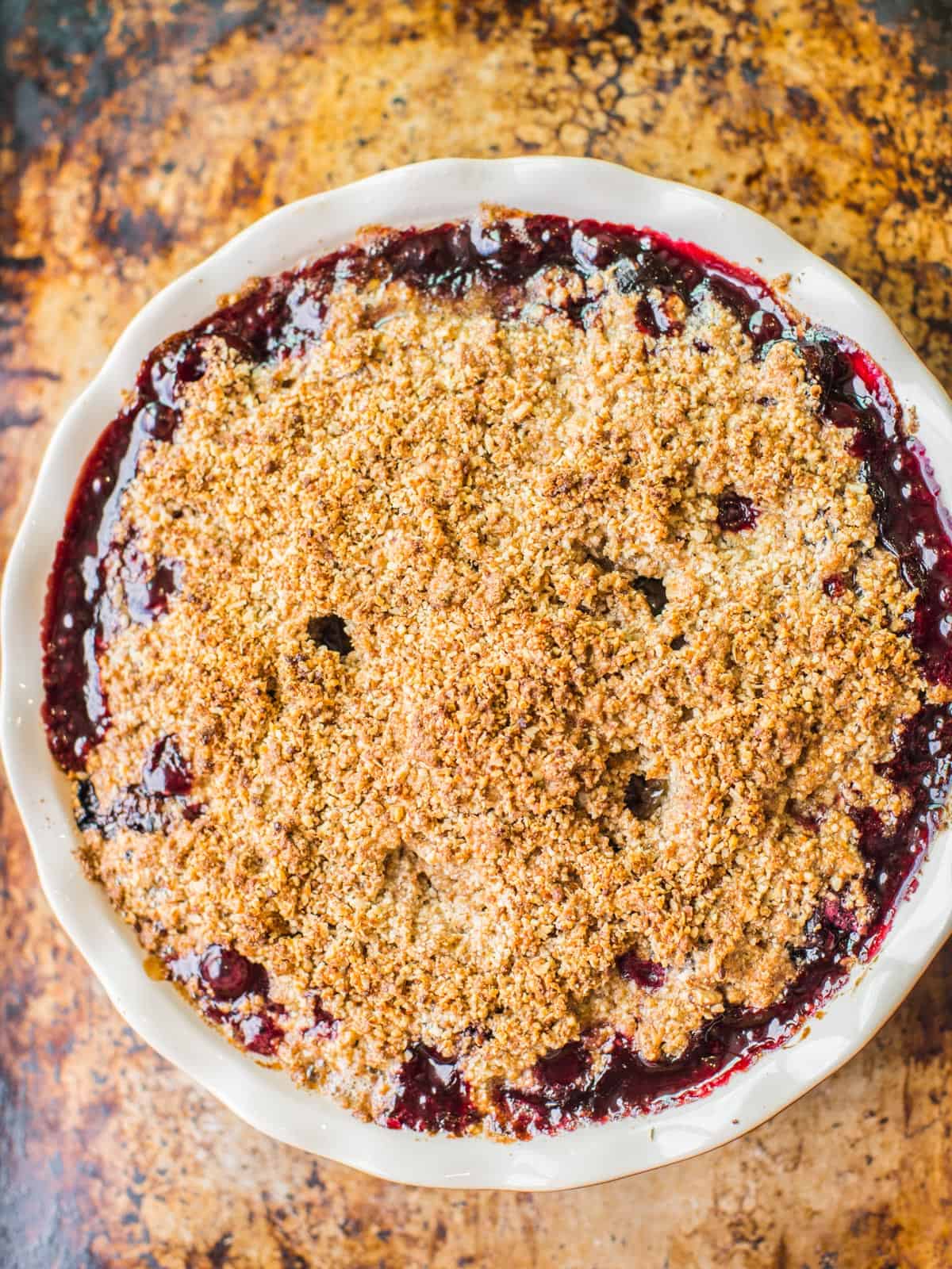 almond crumble topping on a cherry crisp