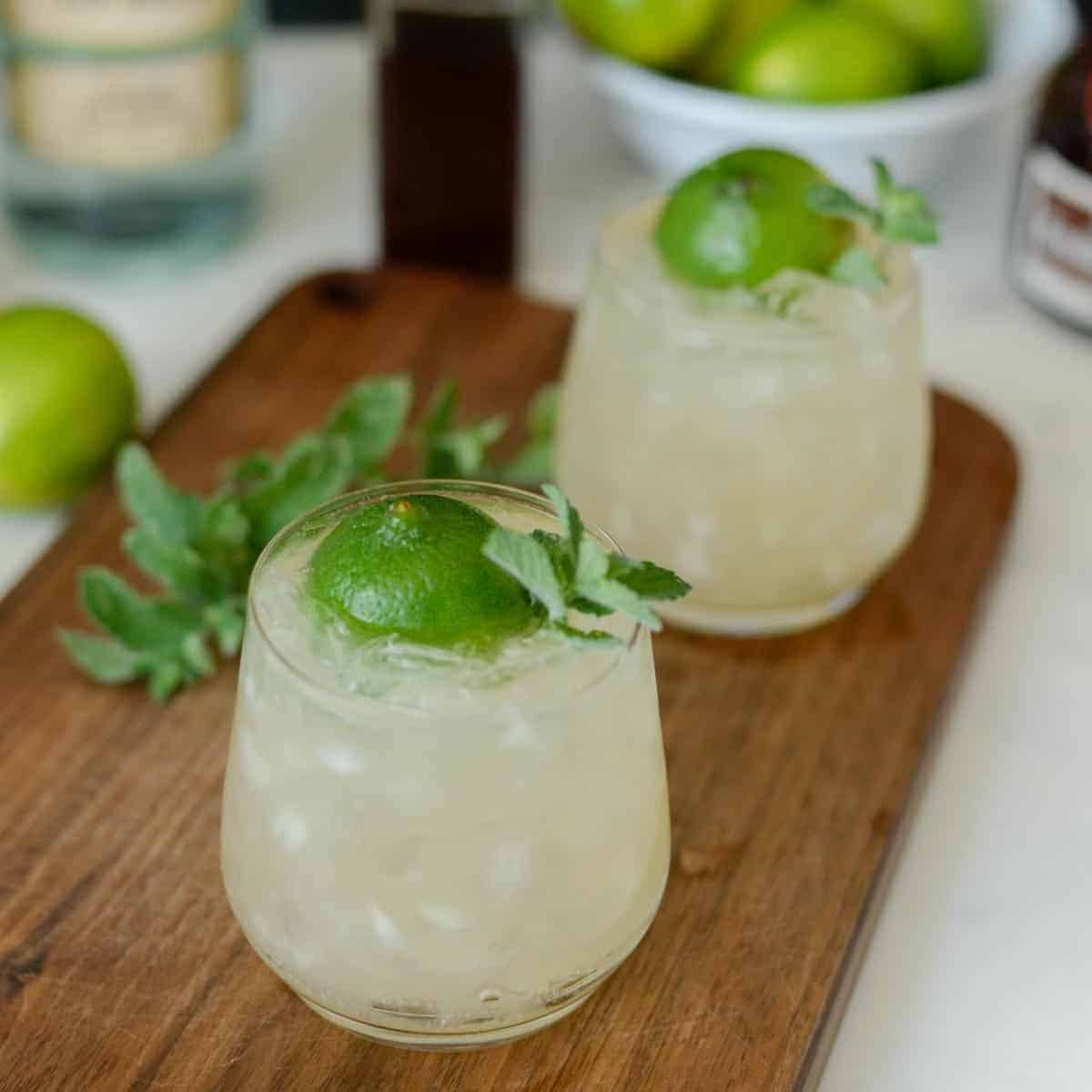 mai tais on a table with fresh limes