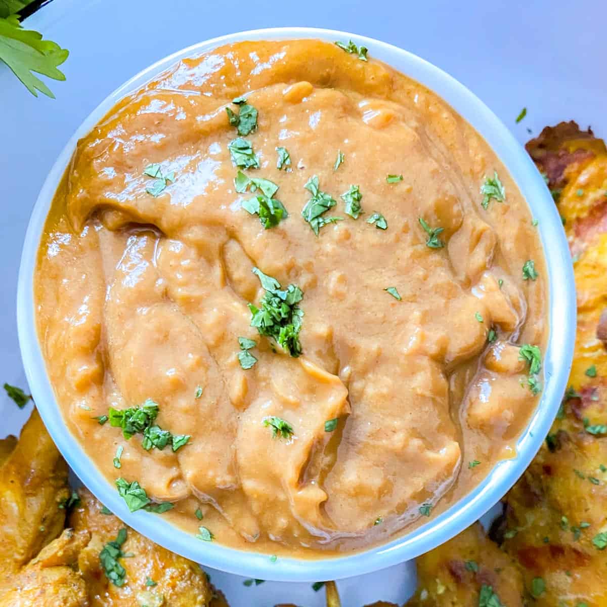 peanut sauce served with chicken satay garnished with chopped coriander