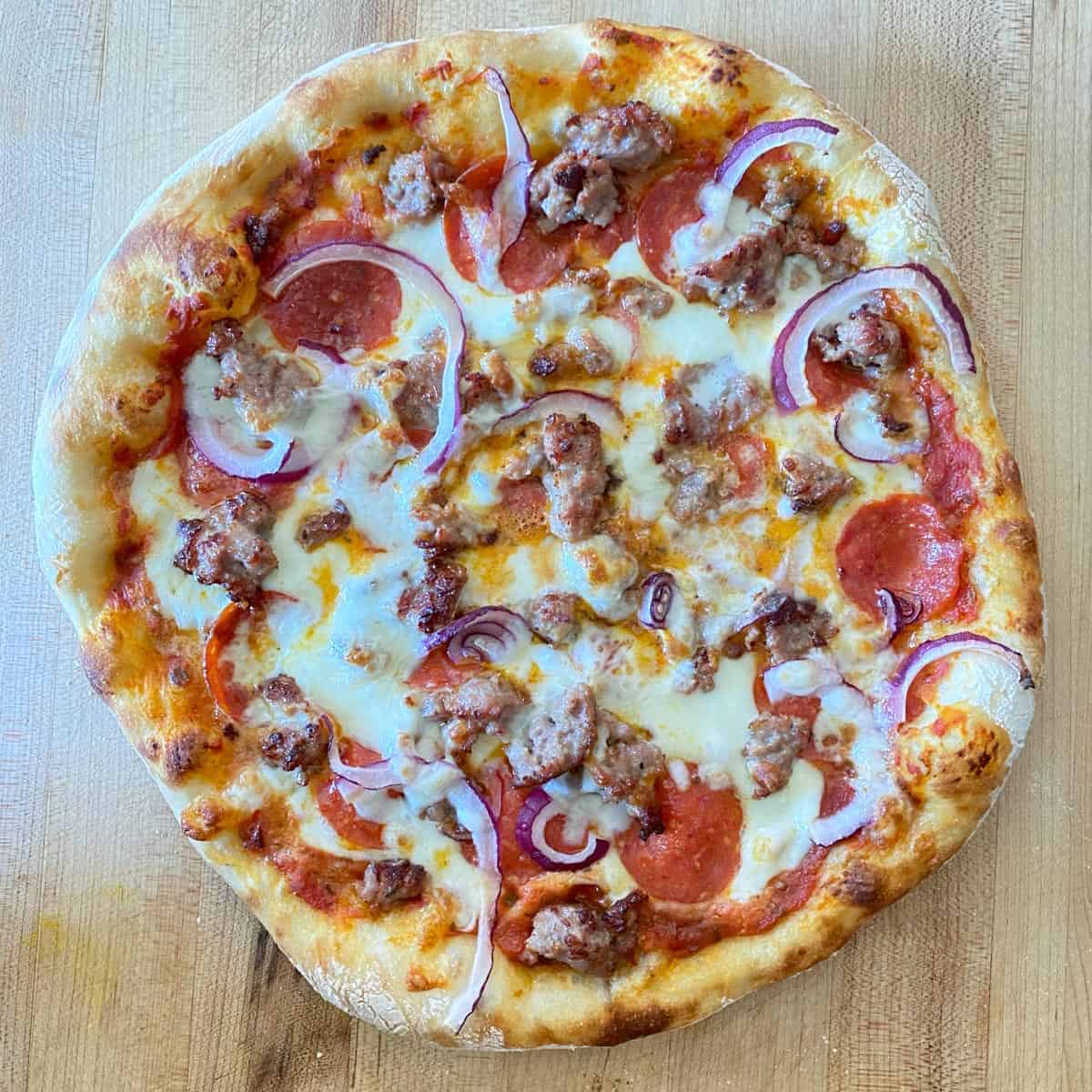 pizza dough recipe topped with sausage and pepperoni
