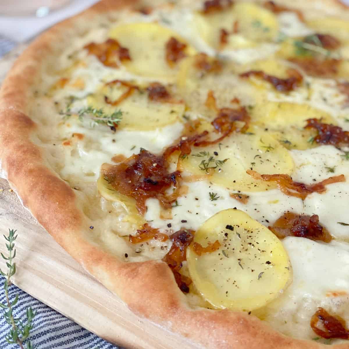 pizza dough topped with caramelized onions and yukon gold potatoes