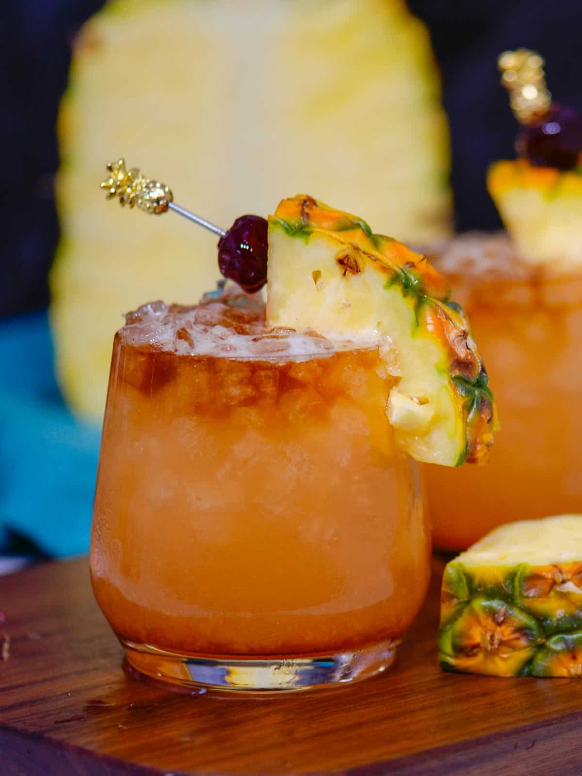 Hawaiian Mai Tai cocktail recipe with pineapple and cherry for a garnish. 