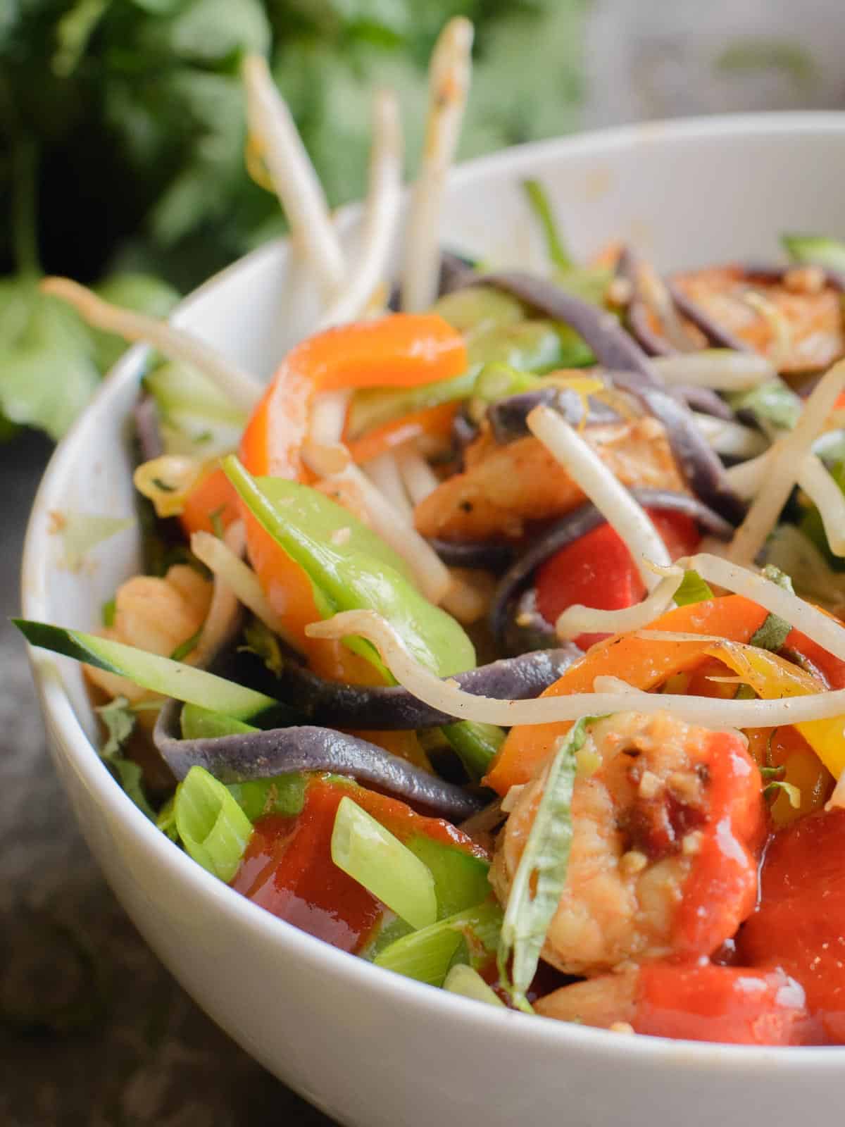 noodle bowls with shrimp, peppers, and onions