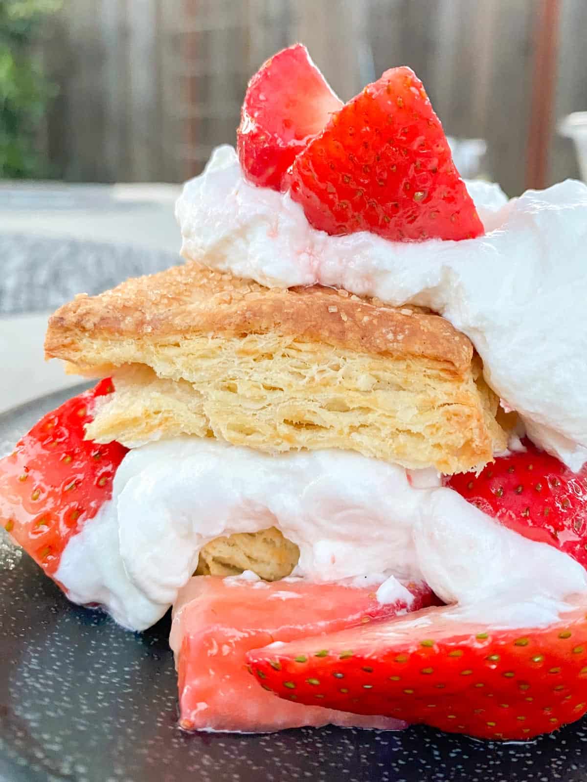 A strawberry shortcake recipe, layered with fresh strawberries and whipped cream.