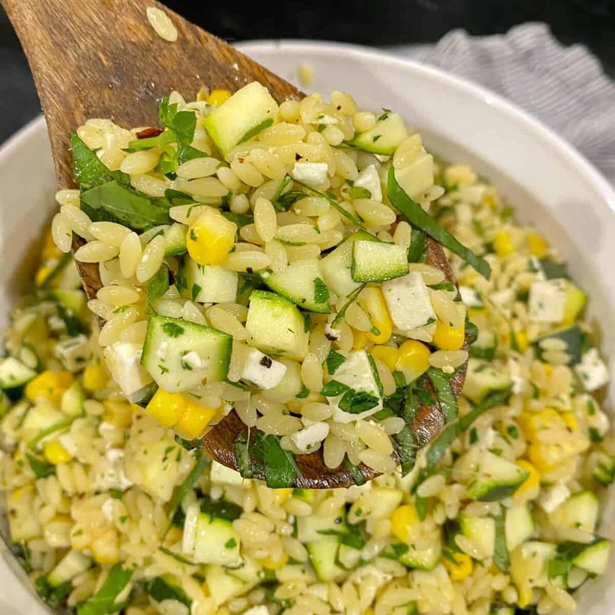 serving orzo salad on a spoon