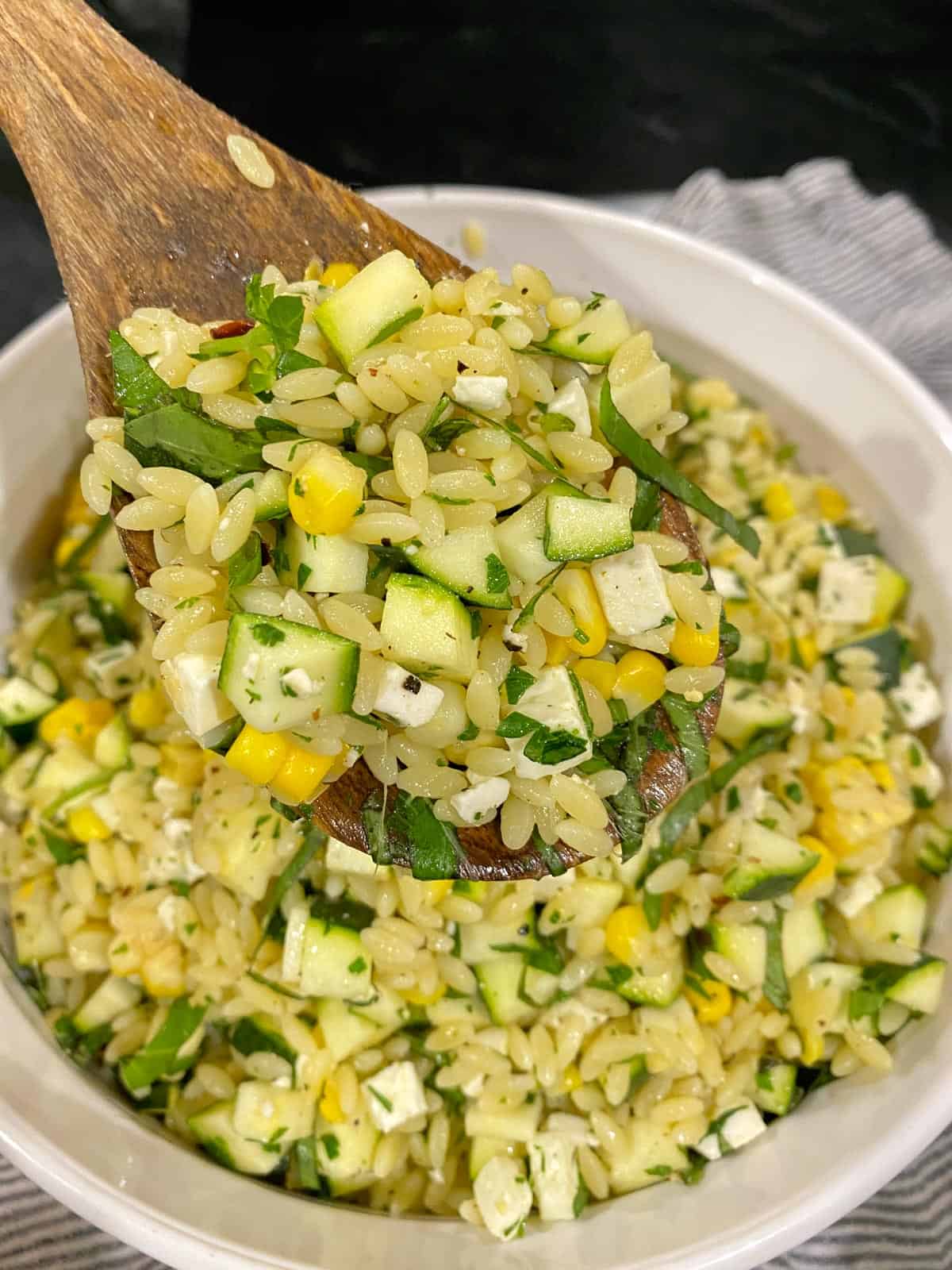 serving orzo salad on a spoon