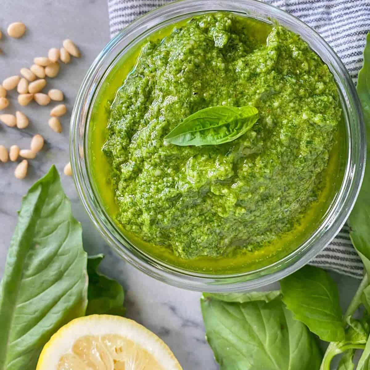 fresh basil pesto recipe in a weck jar with a freshly squeezed lemon