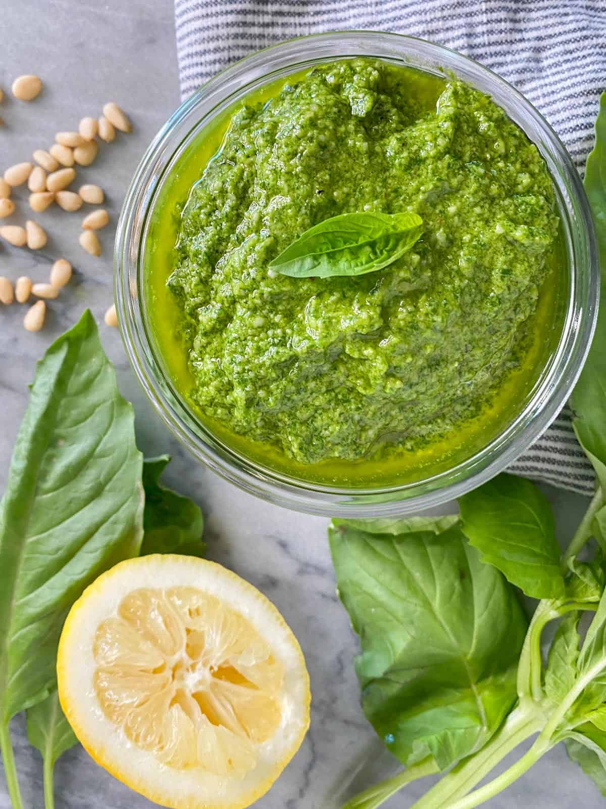 fresh basil pesto recipe in a weck jar with a freshly squeezed lemon