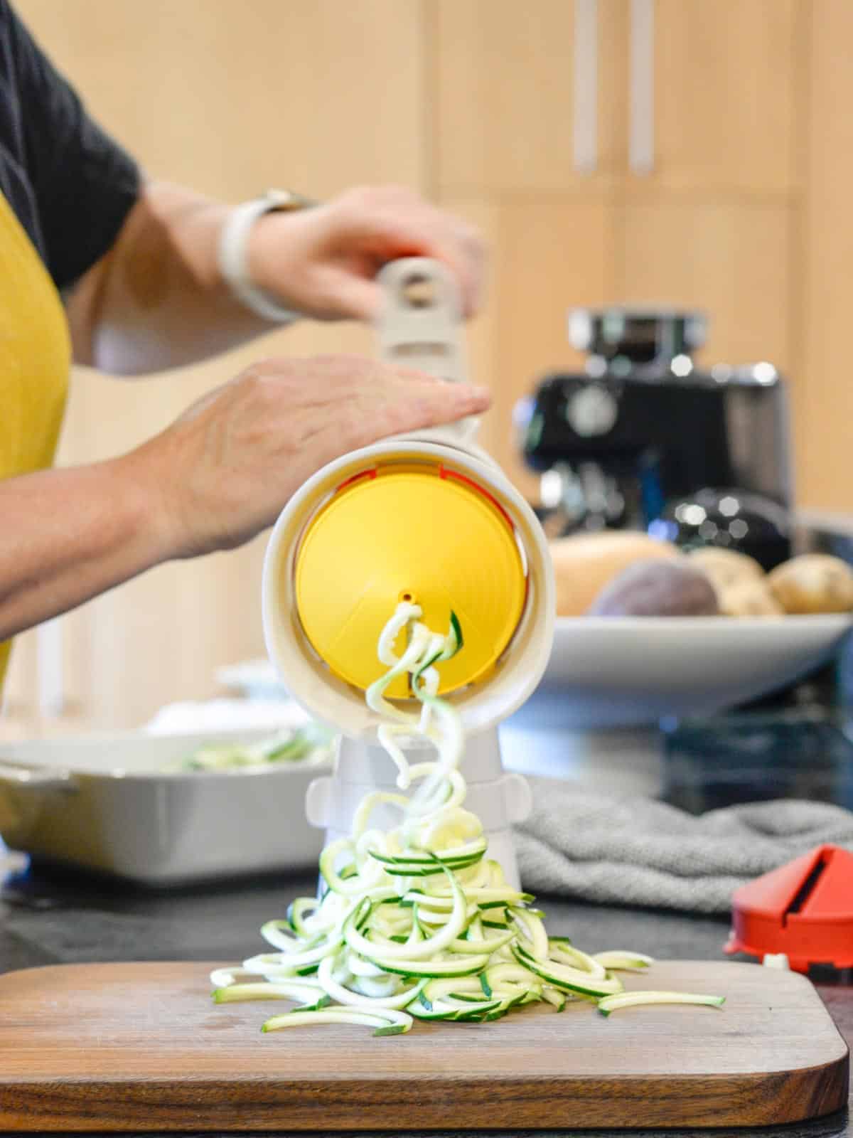 the tupperware spiralizer with the flat blade spiralizing zucchini noodles