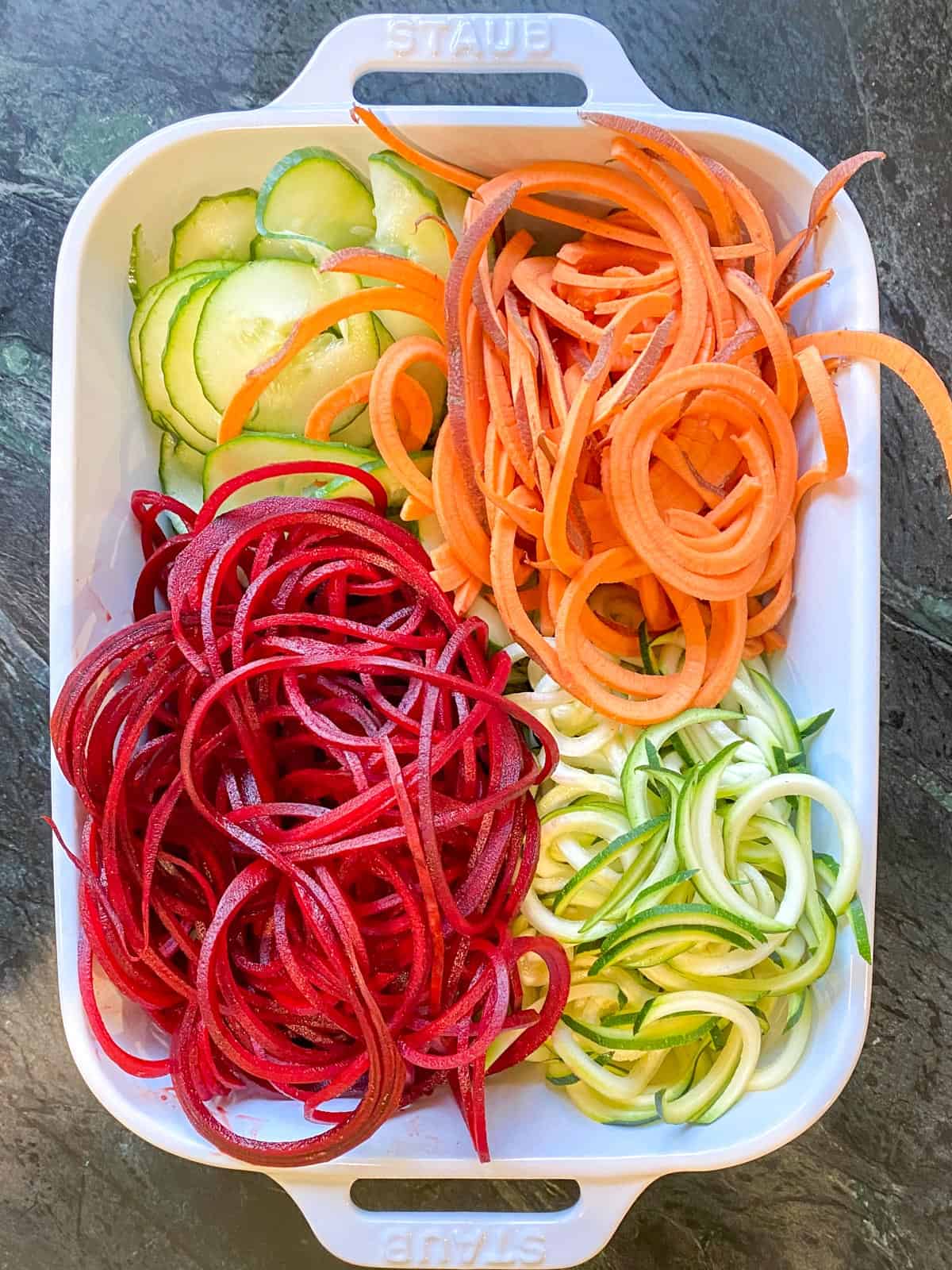 a baking dish filled with different types of veggie noodles