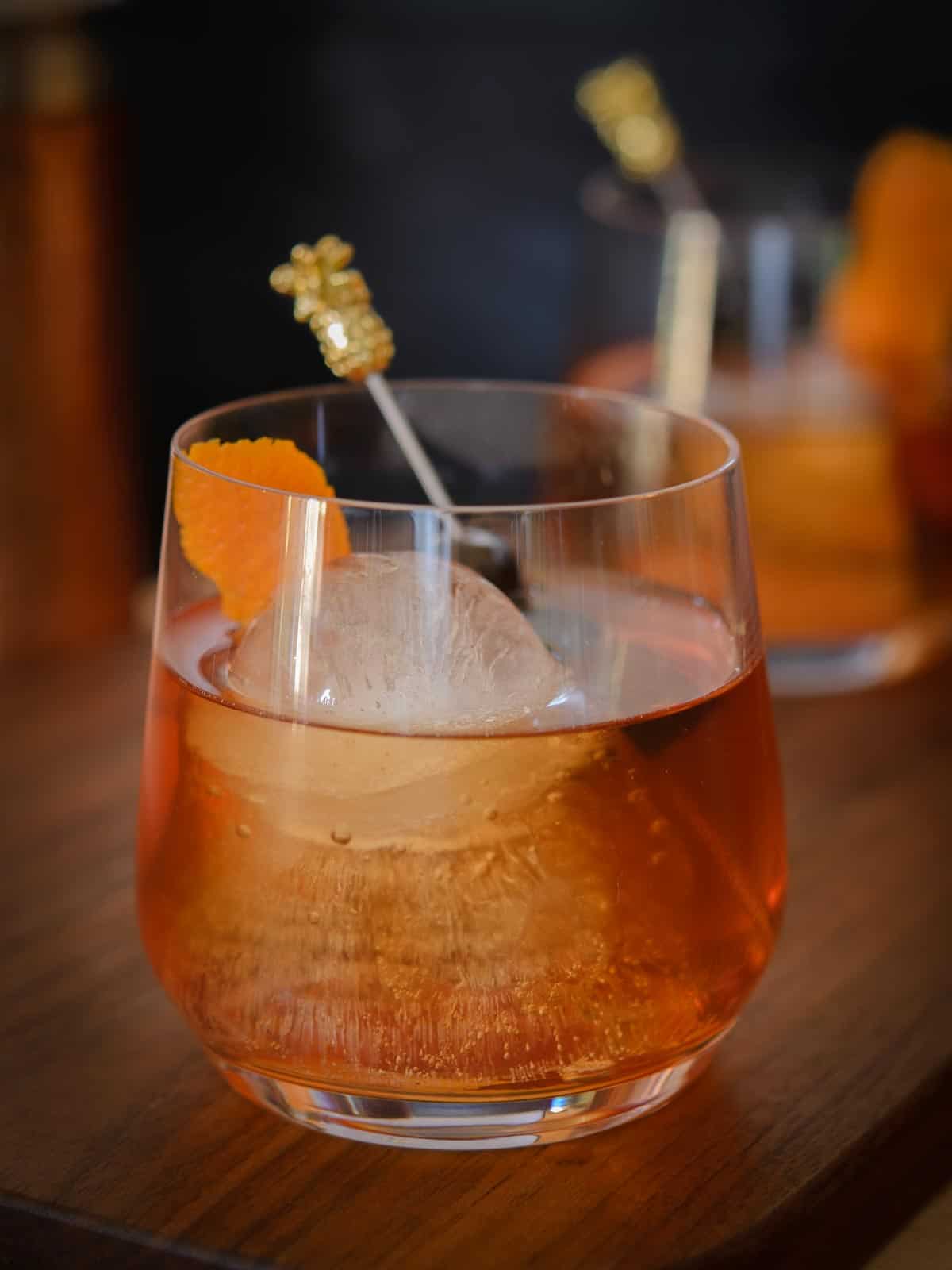old fashioned with orange peel and cherries