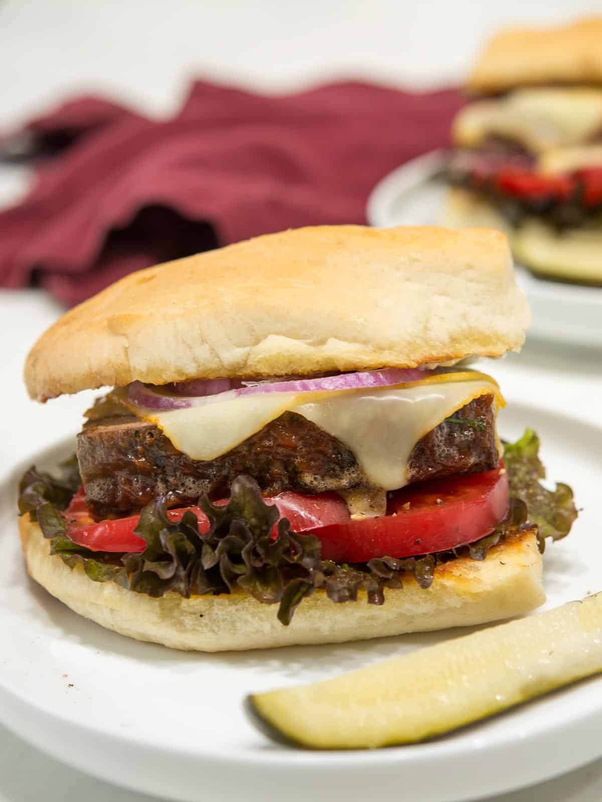 A thick slice of meatloaf on a soft roll, toasted, Topped with melted muenster cheese and onion jam. 