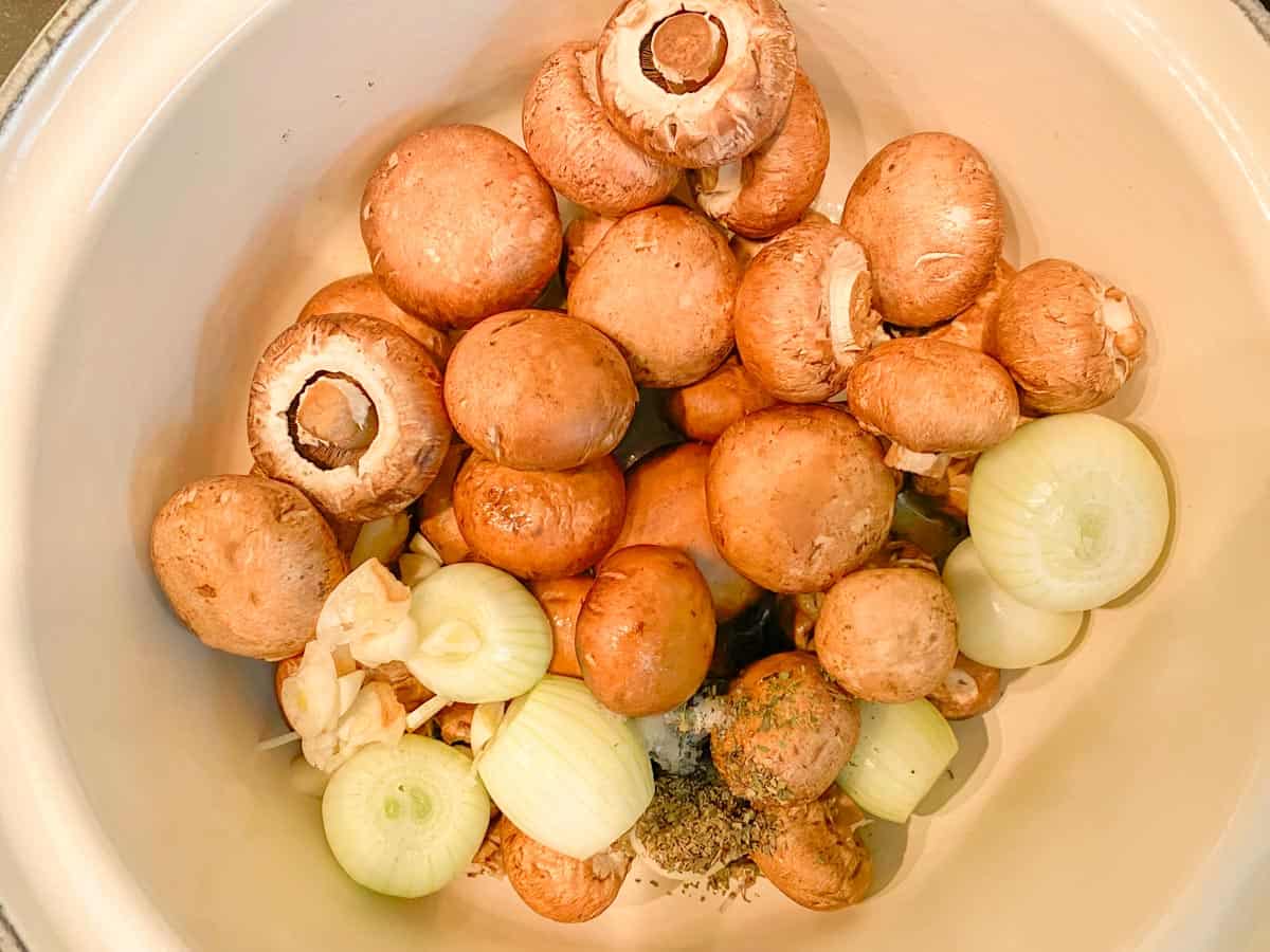 mushrooms and onions in a dutch oven