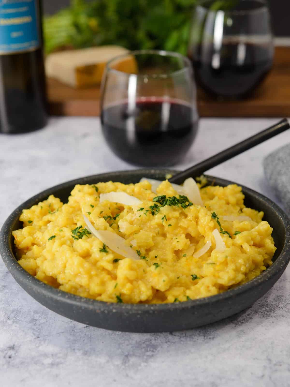 risotto served with a glass of Italian wine