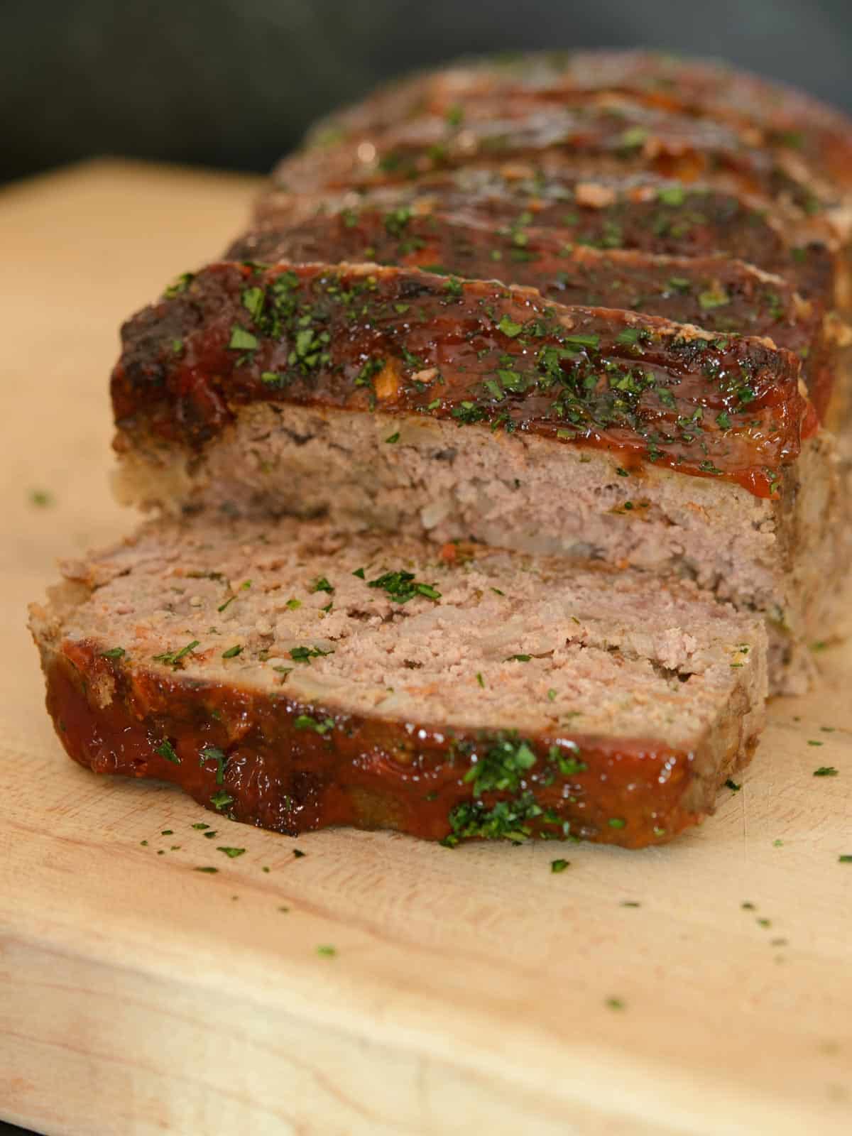 thick slices of meatloaf on a cutting board