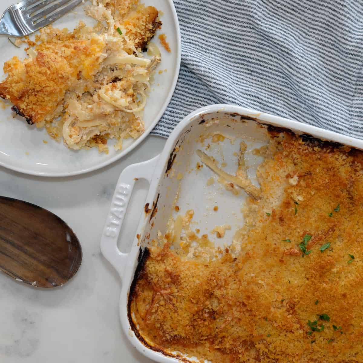 cheesy hashbrown casserole with a plate on the side