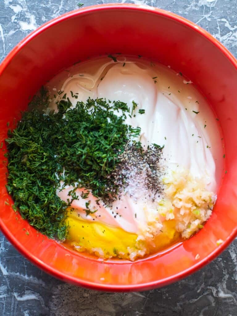 combine the greek yogurt, garlic, dill, salt and pepper, and lemon juice