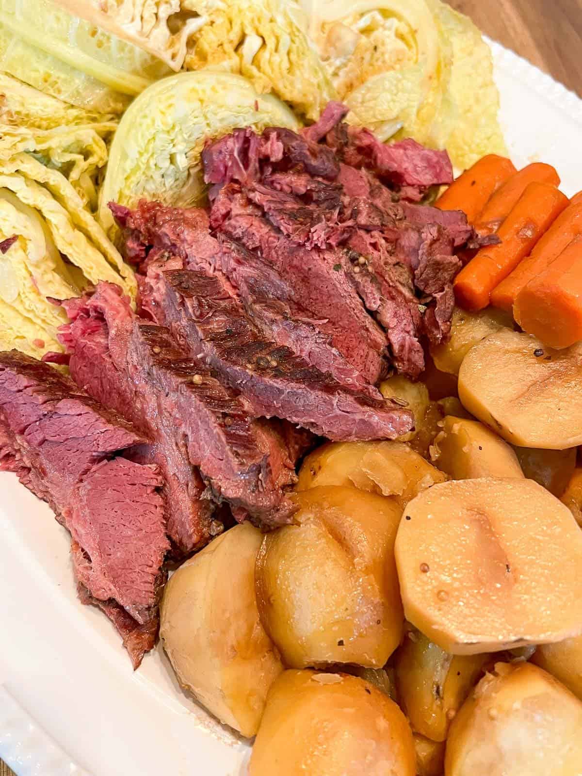 corned beef hash on a platter served with potatoes and carrots