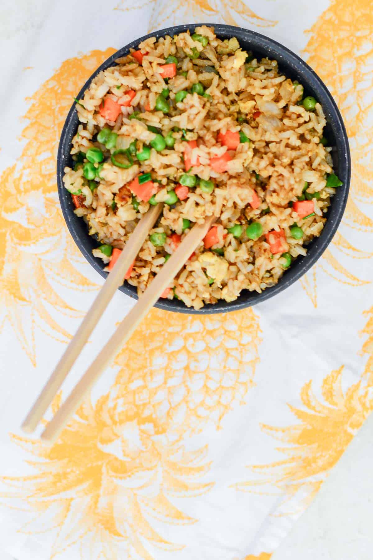 easy fried rice recipe served in a black owl with chopsticks